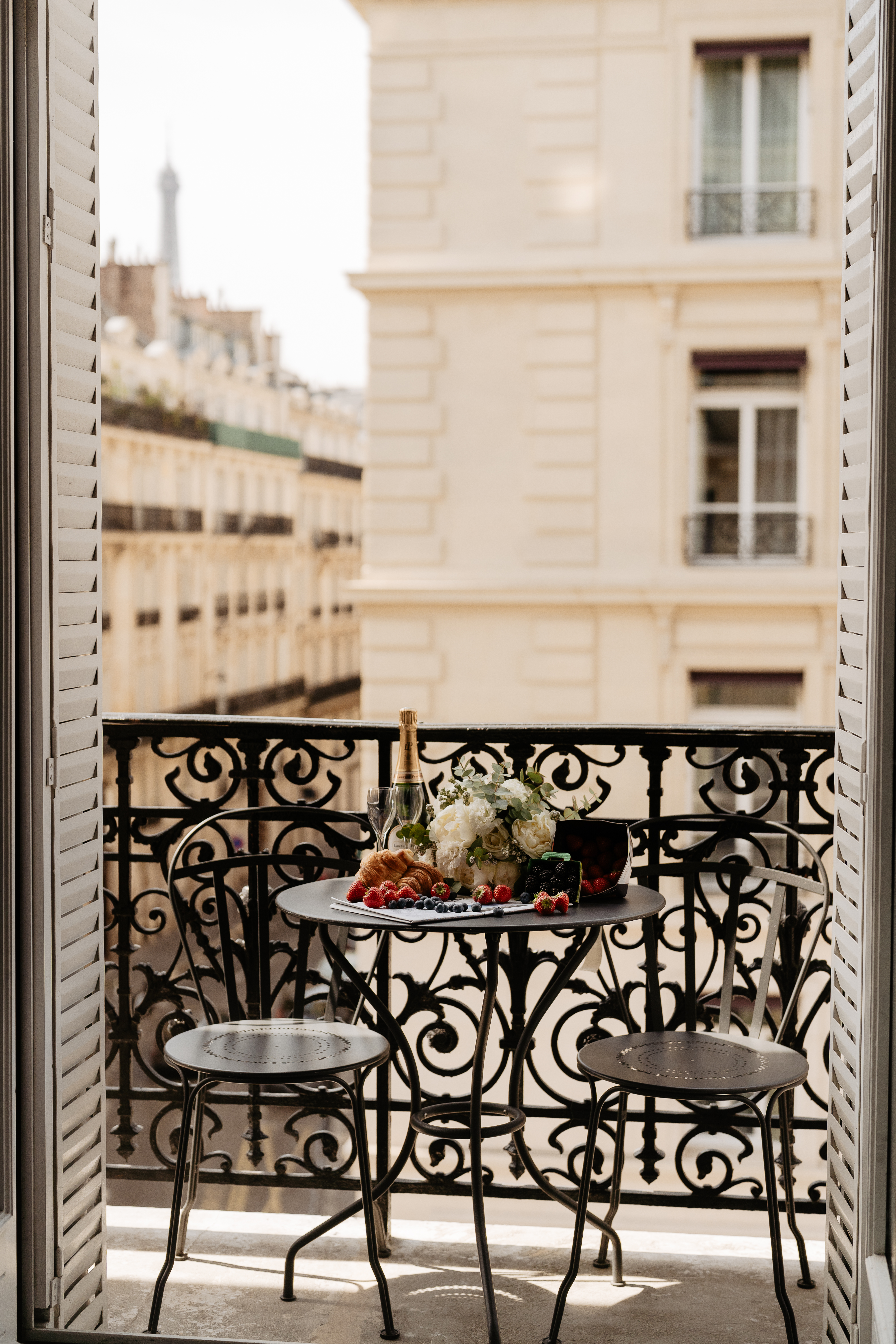 Couple full-day Pre-wedding Photoshoot in Paris hotel balcony with wine and fruits