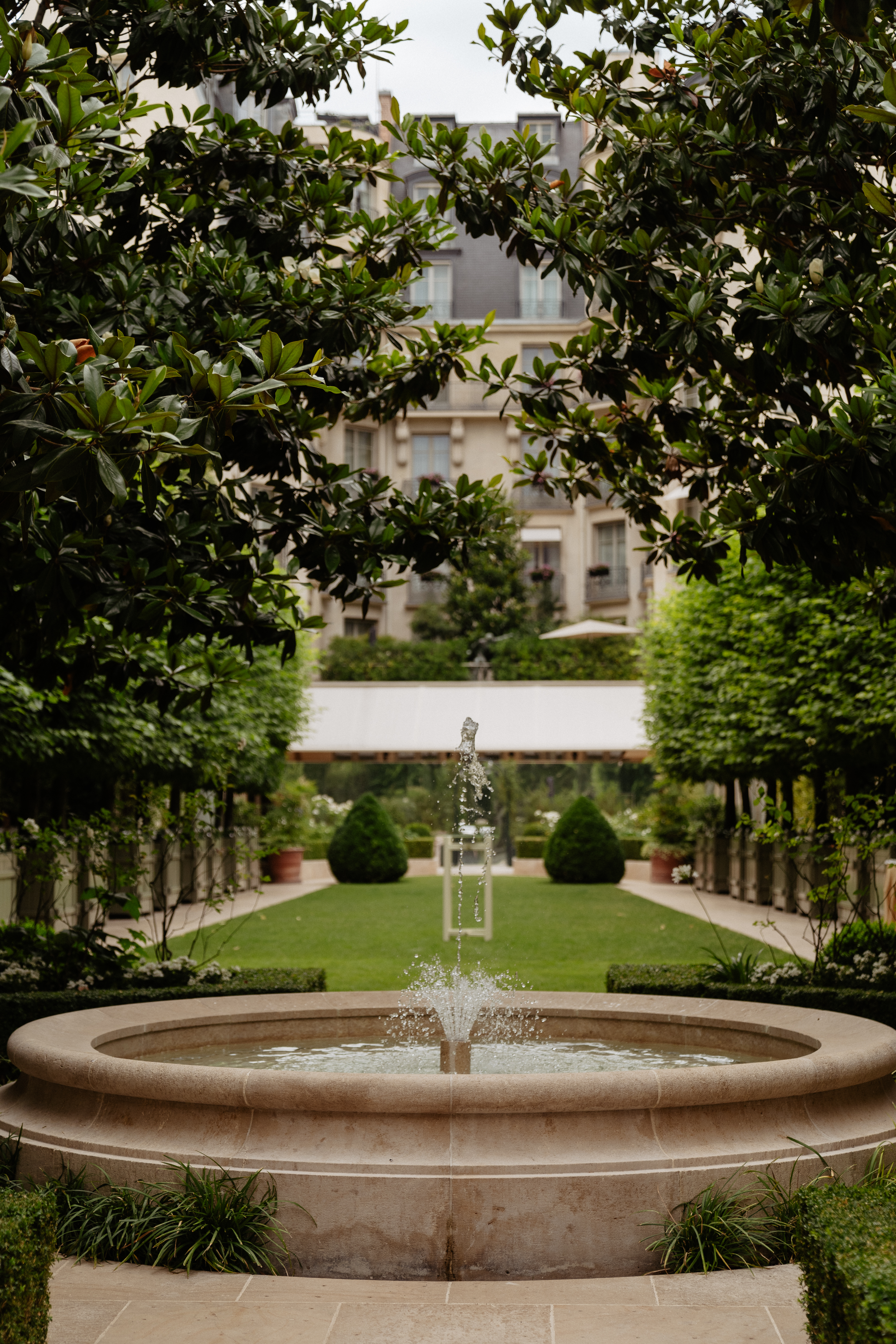 Destination wedding elopement at the luxurious Ritz Paris garden with fountain 