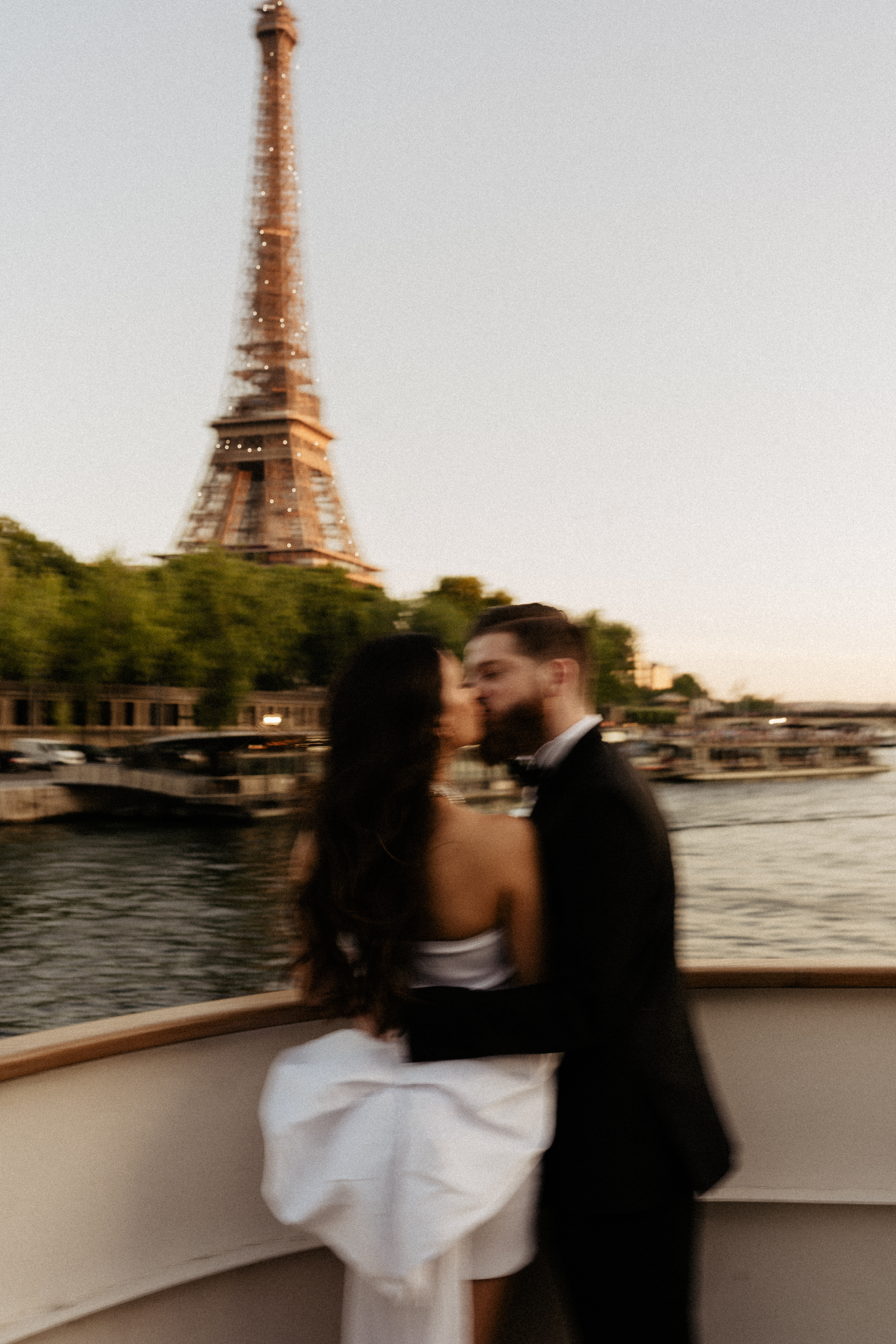 Destination Wedding in Paris Welcome Dinner on Cruise Eiffel Tower view couple kissing