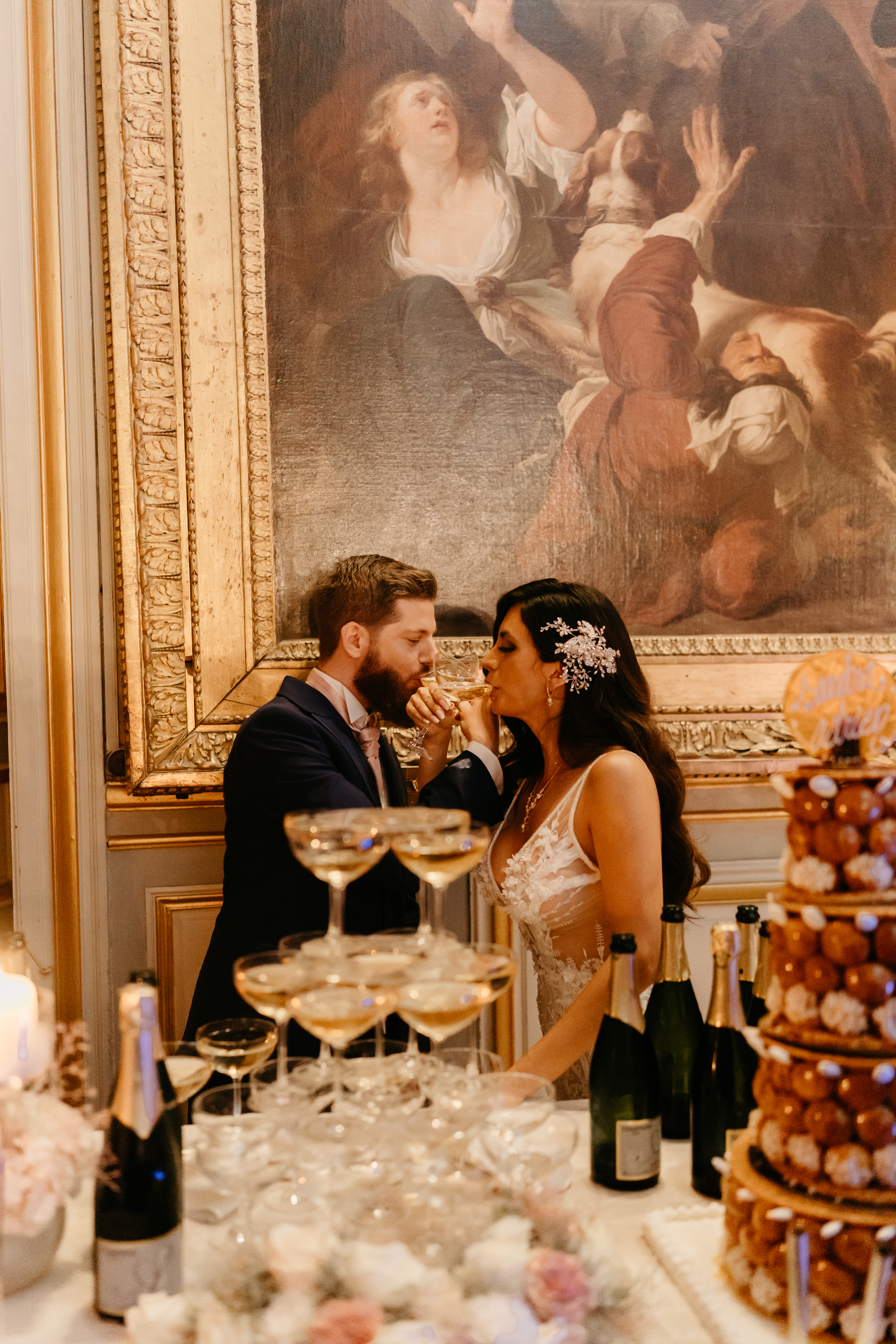 French Destination Wedding at Chateau de Champlatreux champagne tower and cake couple drinking 